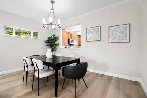 a view of a dining room with furniture and wooden floor