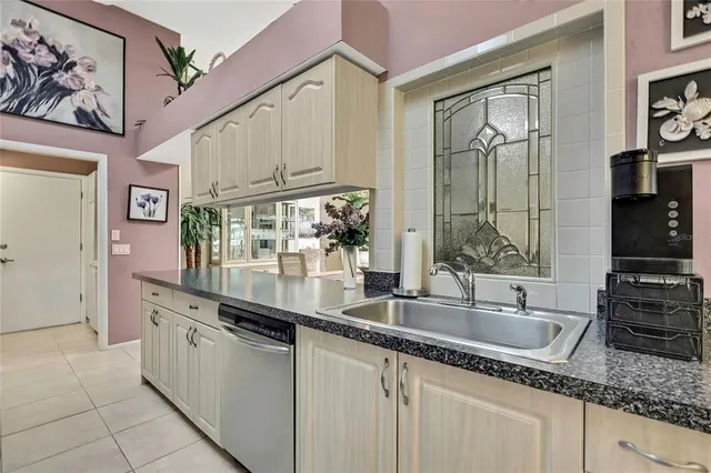 a kitchen with stainless steel appliances granite countertop a sink and a refrigerator