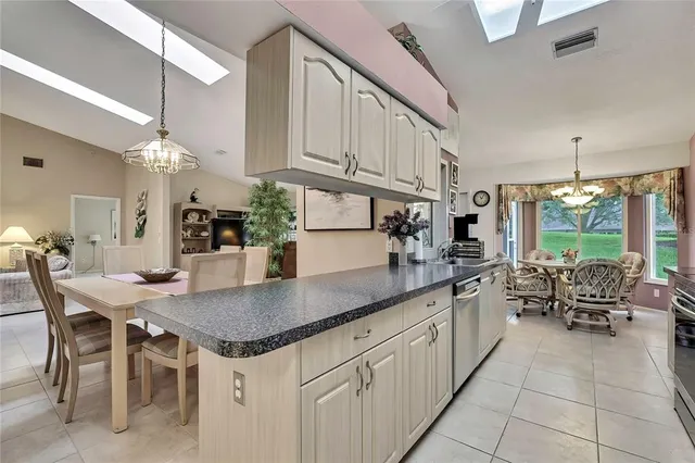 a kitchen with granite countertop lots of counter space and windows