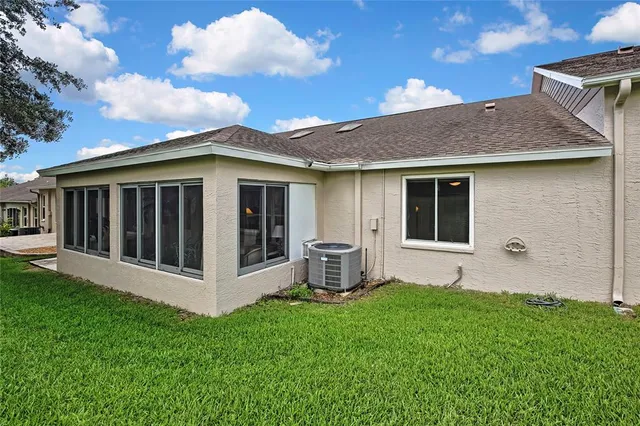 a view of a house with backyard and a garden