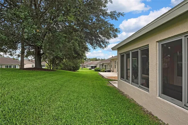 a view of a backyard with large trees