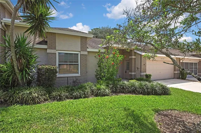 a front view of house with yard and green space