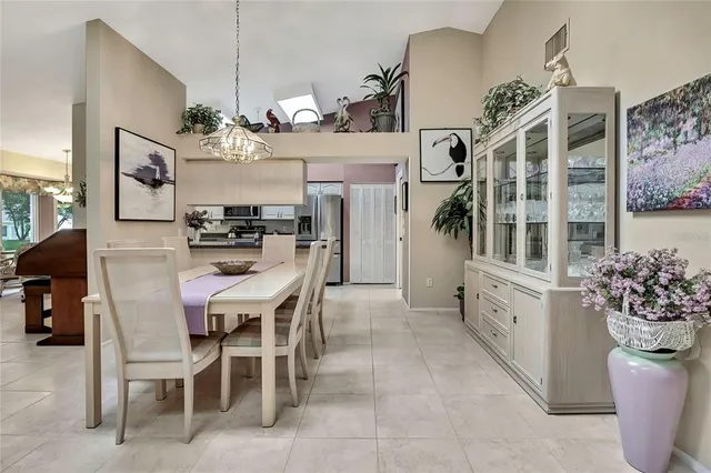 a view of a dining room with furniture and chandelier
