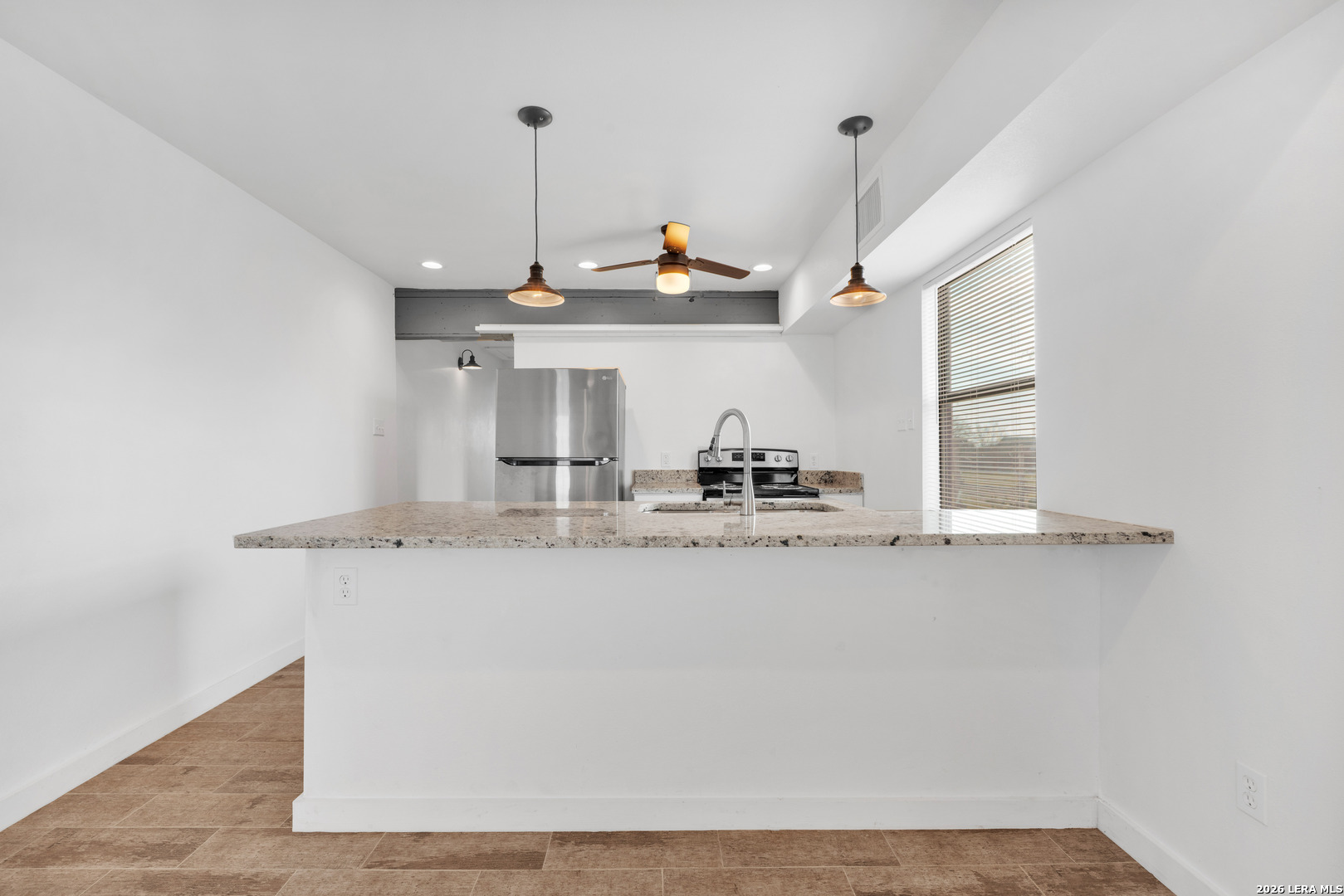 18460 Interstate 37 Elmendorf, TX 78112 - Photo 21 of 28 a kitchen with a sink a window and chairs
