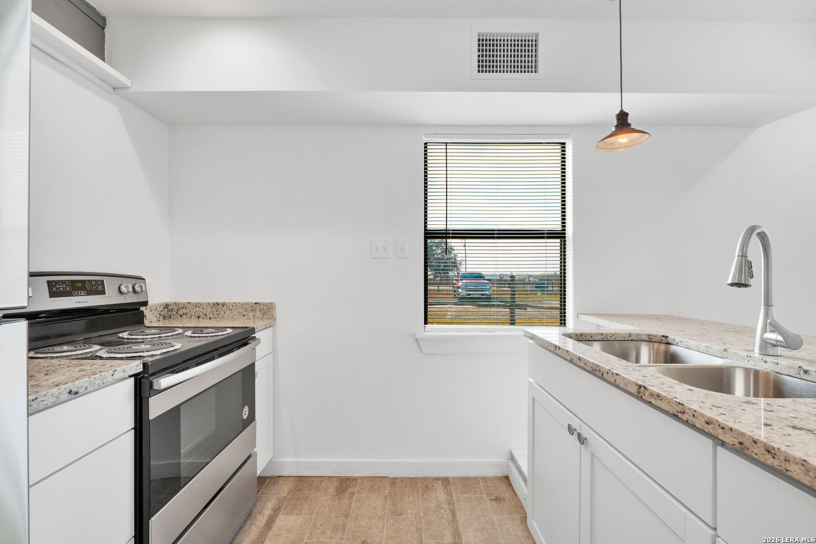 18460 Interstate 37 Elmendorf, TX 78112 - Photo 22 of 28 a kitchen that has a sink a stove and window