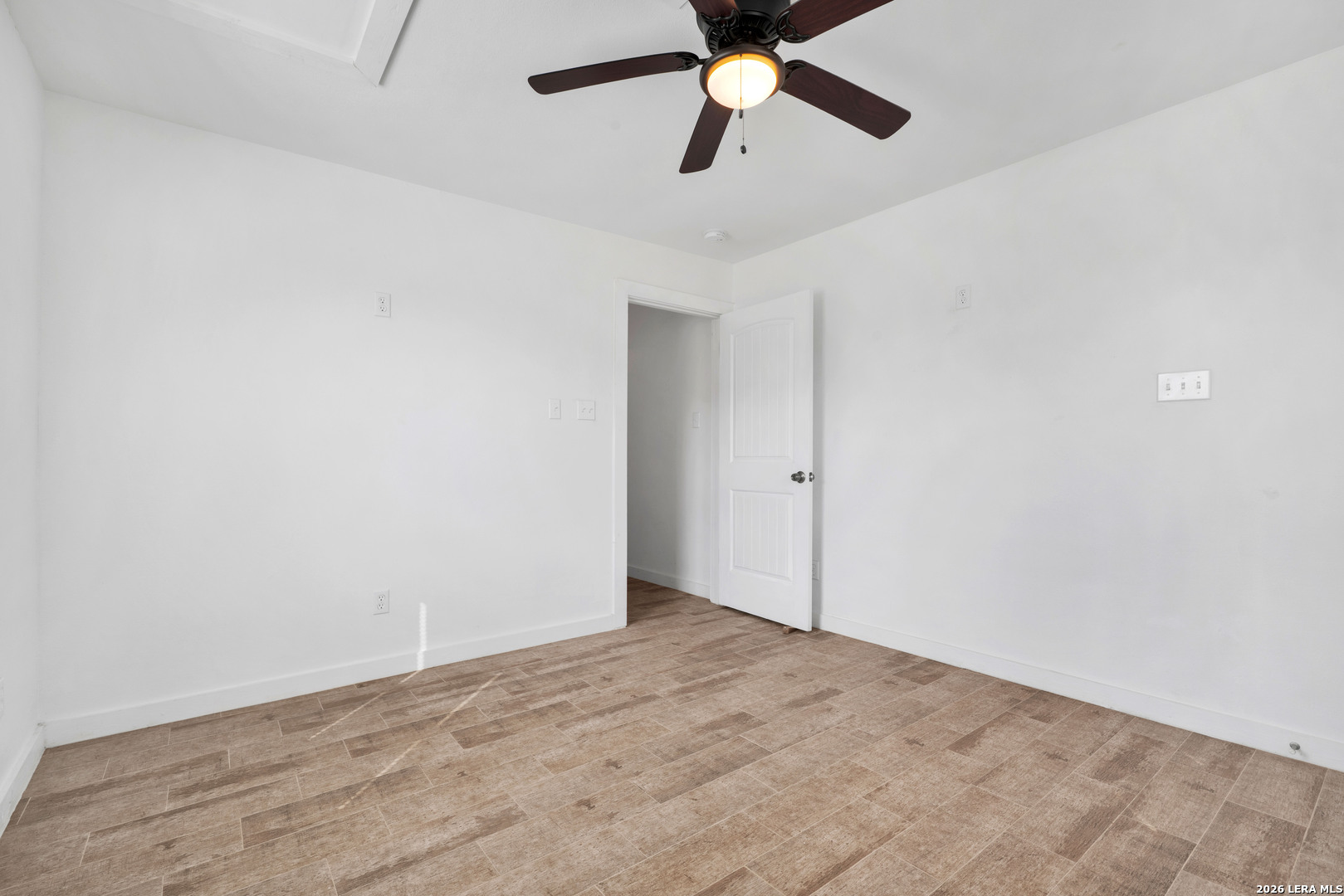 18460 Interstate 37 Elmendorf, TX 78112 - Photo 26 of 28 an empty room with wooden floor and windows