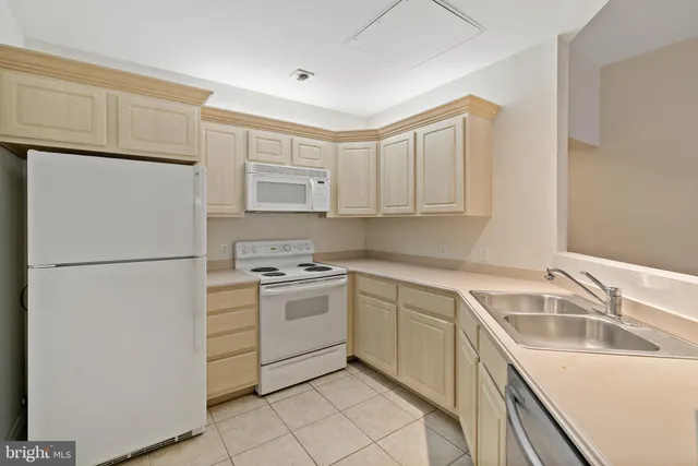 a kitchen with a refrigerator sink stove and cabinets