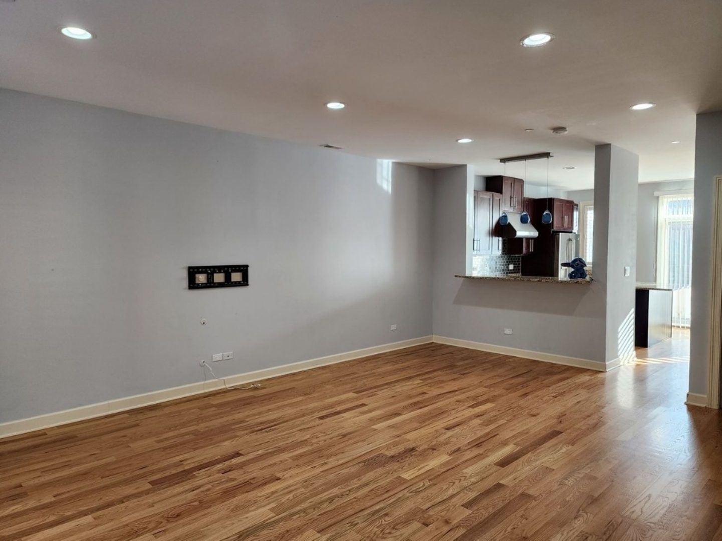 92 Legacy Lane Wheeling, IL 60090 - Photo 2 of 4 a view of a livingroom with wooden floor and a ceiling fan