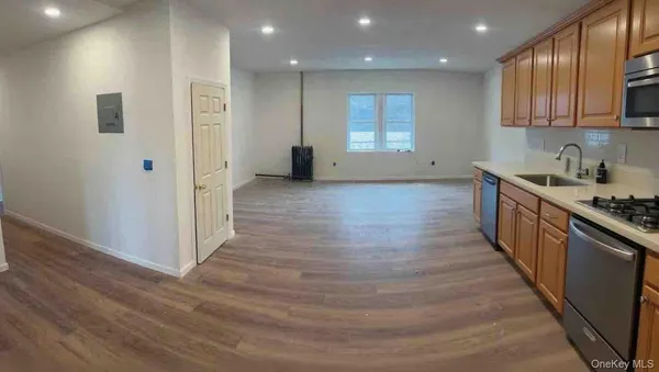 a large kitchen with stainless steel appliances granite countertop a stove and a refrigerator