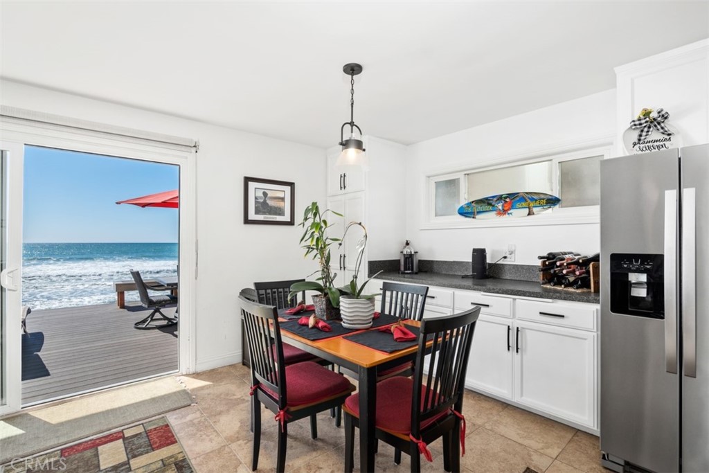 35725 Beach Road Dana Point, CA 92624 - Photo 13 of 40 a dining room with furniture a chandelier and kitchen view