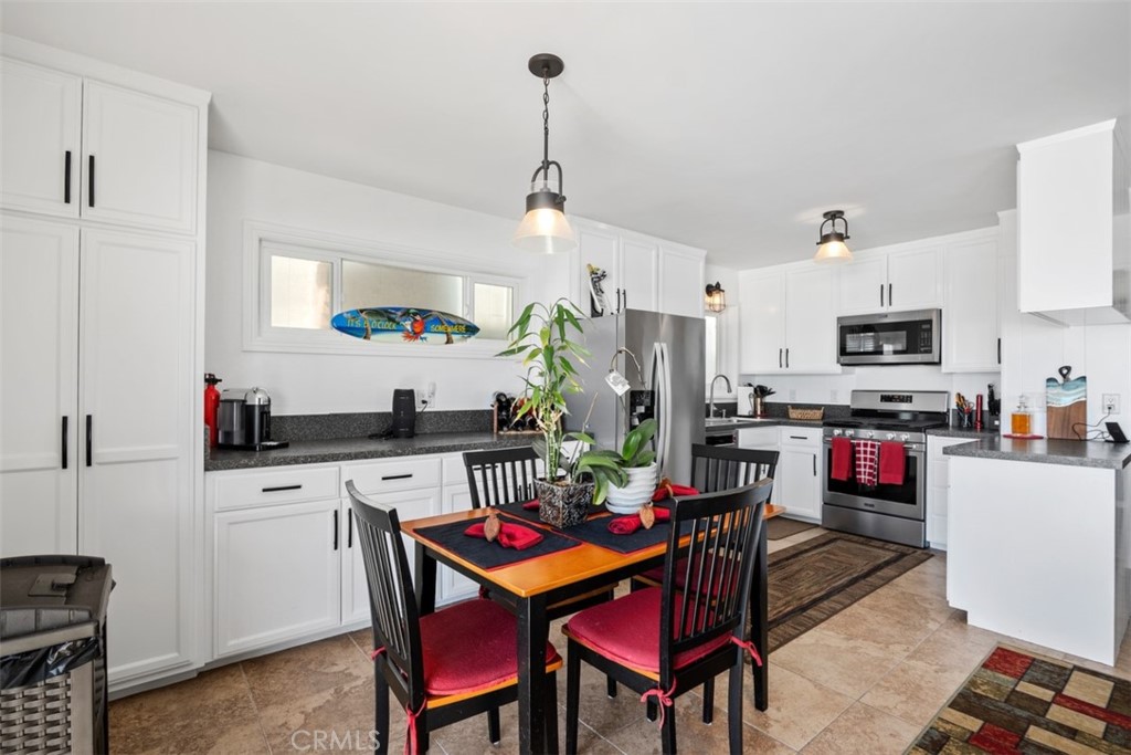 35725 Beach Road Dana Point, CA 92624 - Photo 14 of 40 a kitchen that has a table chairs appliances and cabinets