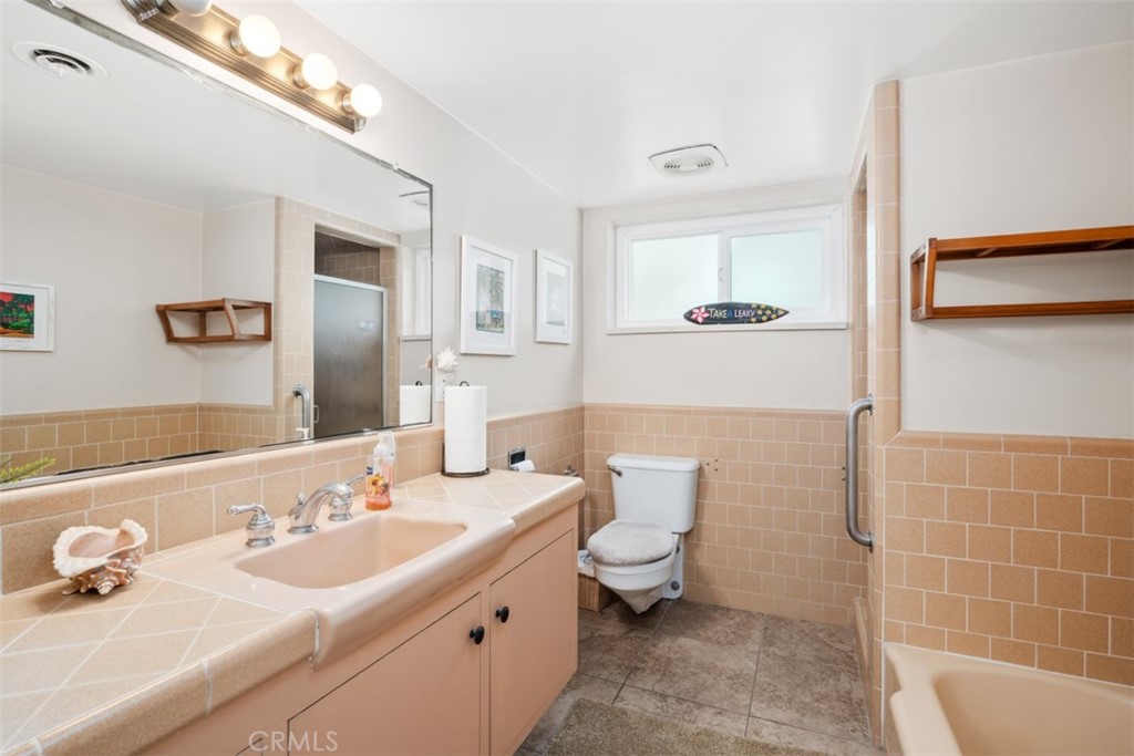 35725 Beach Road Dana Point, CA 92624 - Photo 18 of 40 a bathroom with a double vanity sink a mirror and a toilet