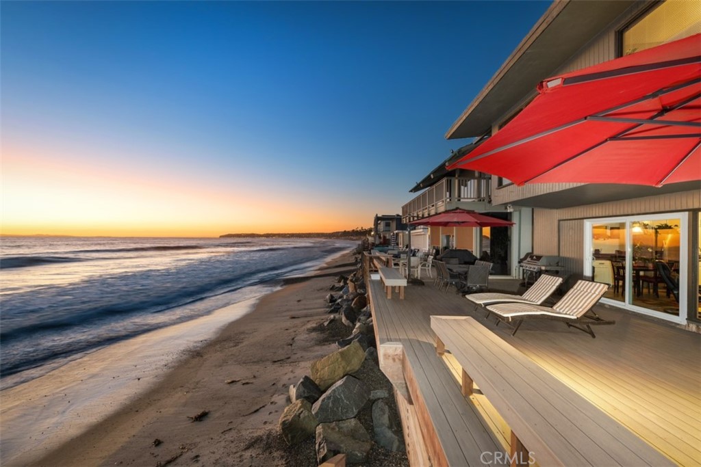 35725 Beach Road Dana Point, CA 92624 - Photo 2 of 40 a view of a patio with lawn chairs under an umbrella