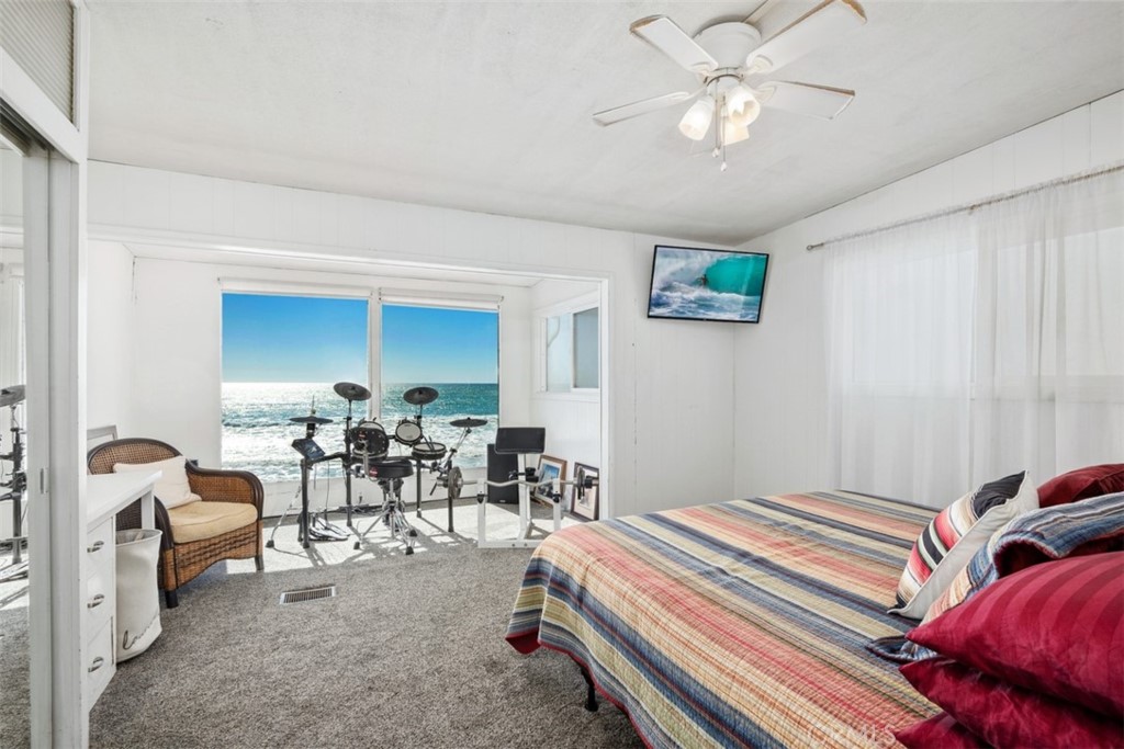 35725 Beach Road Dana Point, CA 92624 - Photo 21 of 40 a bedroom with furniture and a chandelier