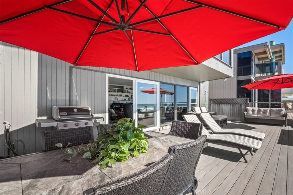 35725 Beach Road Dana Point, CA 92624 - Photo 28 of 40 a view of a patio with table and chairs under an umbrella