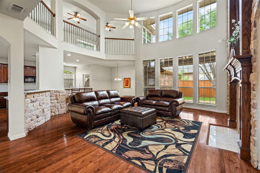 2012 Burnside Drive Allen, TX 75013 - Photo 10 of 40 a living room with furniture a flat screen tv and a floor to ceiling window