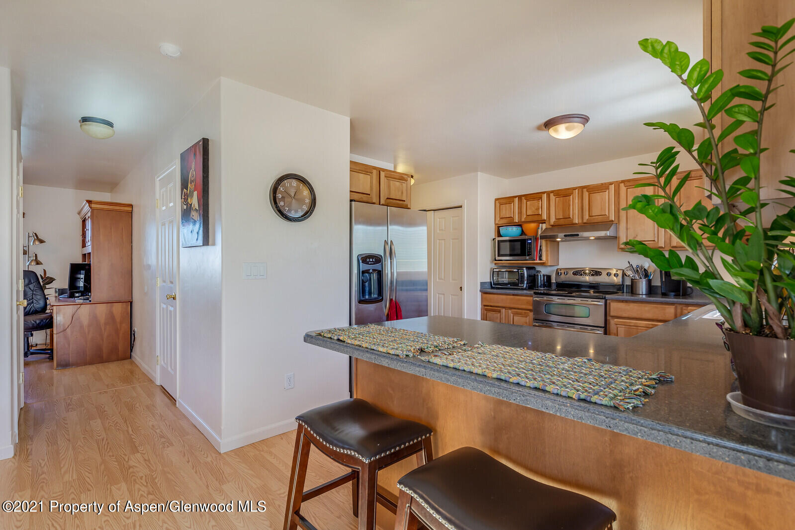 925 East 18th Street Rifle, CO 81650 - Photo 7 of 24 a kitchen with granite countertop a table and chairs in it