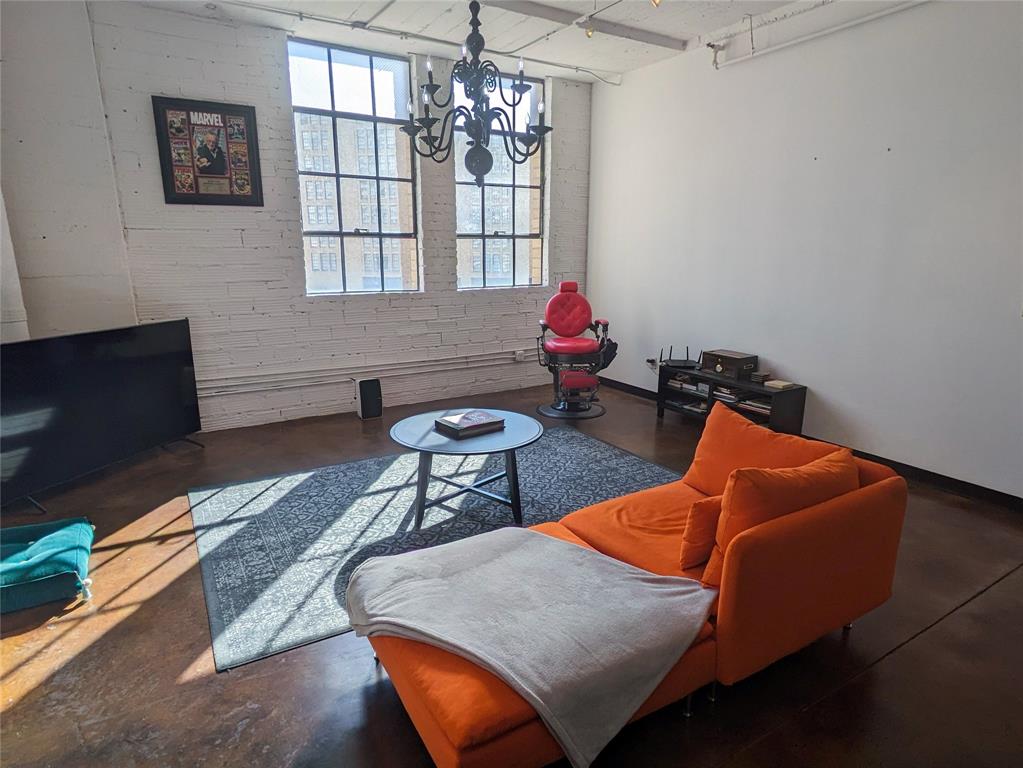 1122 Jackson Street, Unit 301 Dallas, TX 75202 - Photo 13 of 23 a living room with furniture and a chandelier