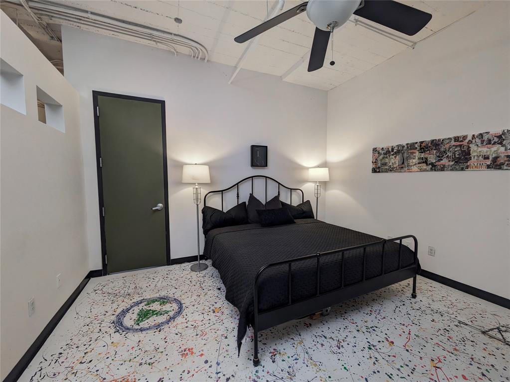 1122 Jackson Street, Unit 301 Dallas, TX 75202 - Photo 15 of 23 a bedroom with a bed and wooden floor