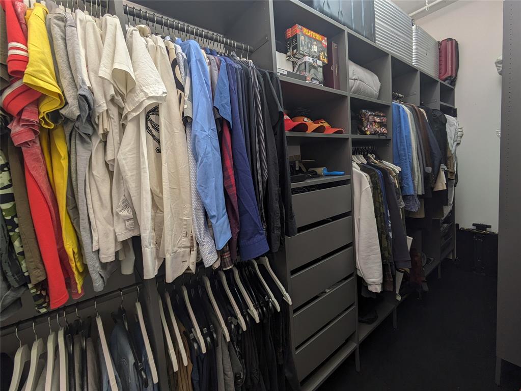 1122 Jackson Street, Unit 301 Dallas, TX 75202 - Photo 17 of 23 a view of walk in closet with clothes