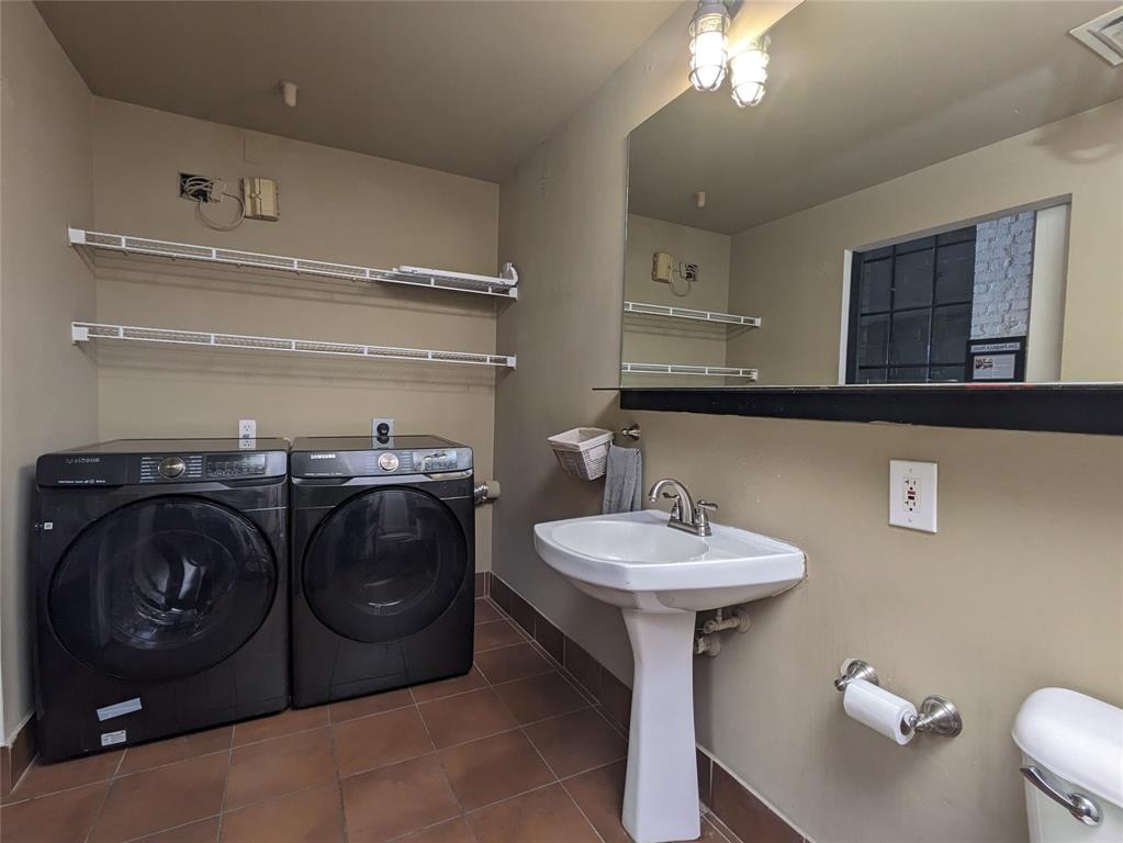 1122 Jackson Street, Unit 301 Dallas, TX 75202 - Photo 19 of 23 a bathroom with a sink and a mirror