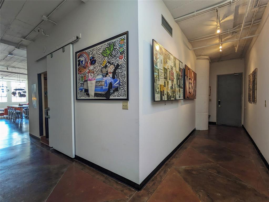 1122 Jackson Street, Unit 301 Dallas, TX 75202 - Photo 2 of 23 a view of a hallway with workspace