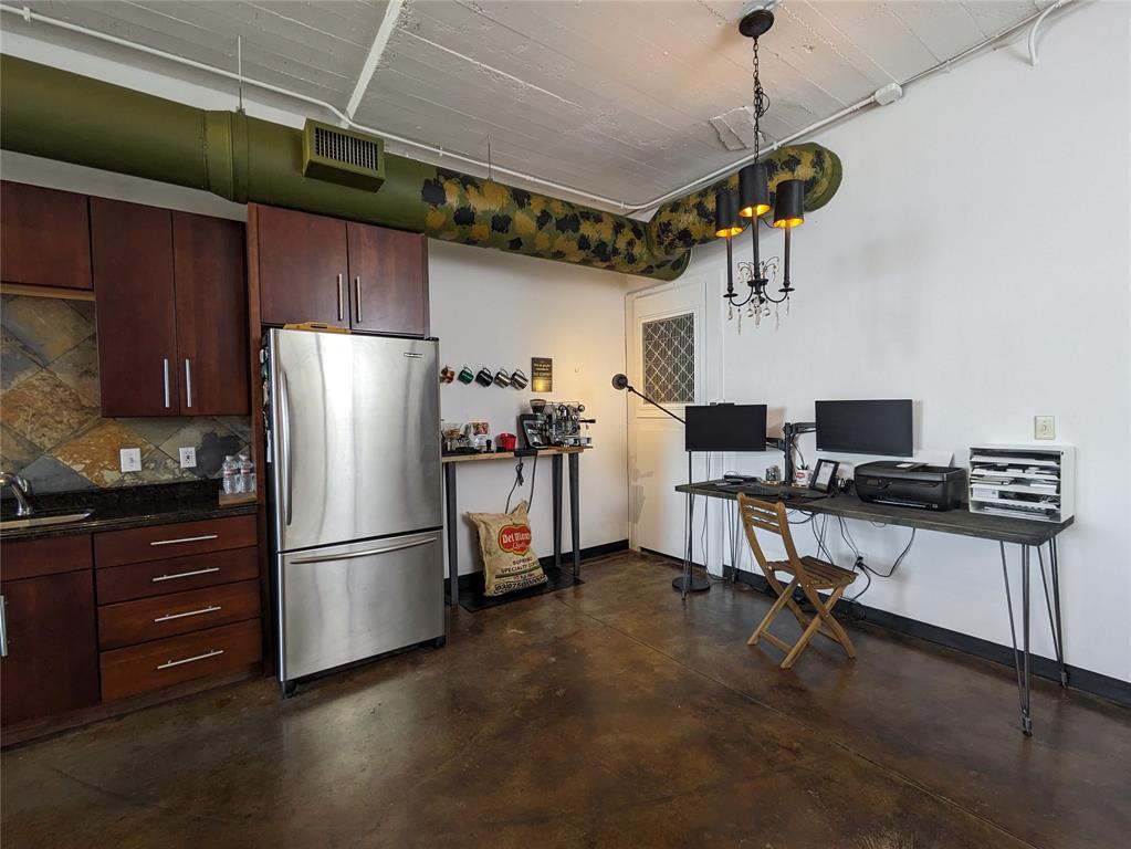 1122 Jackson Street, Unit 301 Dallas, TX 75202 - Photo 10 of 23 a kitchen with stainless steel appliances a refrigerator and a stove top oven