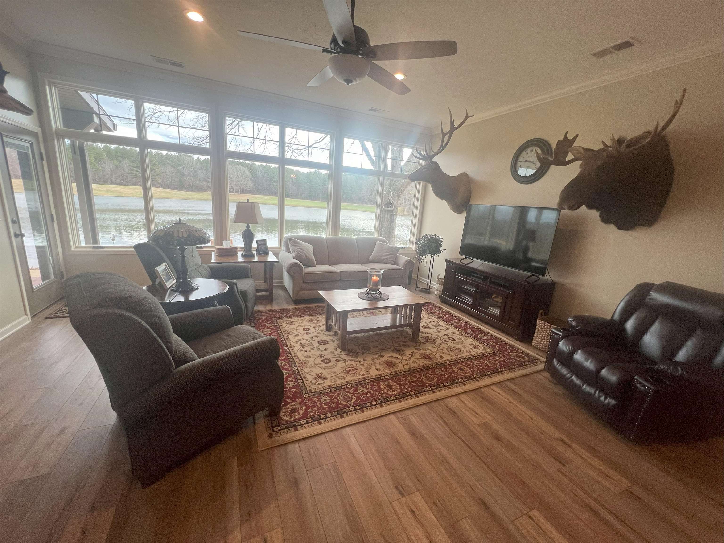 1231 Murray School Road Selmer, TN 38375 - Photo 8 of 39 Living room with a wealth of natural light, ceiling fan, crown molding, and wood-type flooring