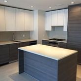 a kitchen with kitchen island cabinets and appliances