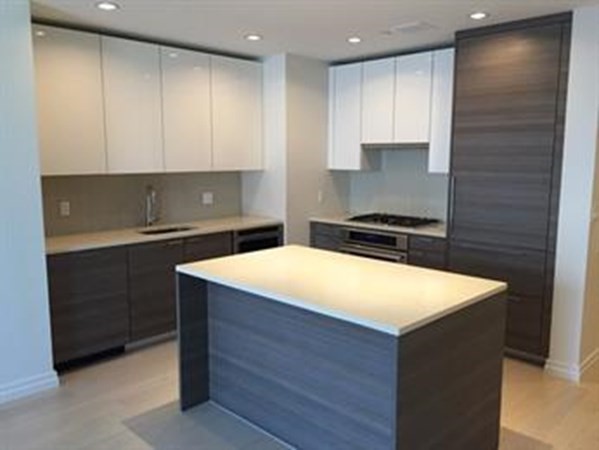 a kitchen with kitchen island cabinets and appliances