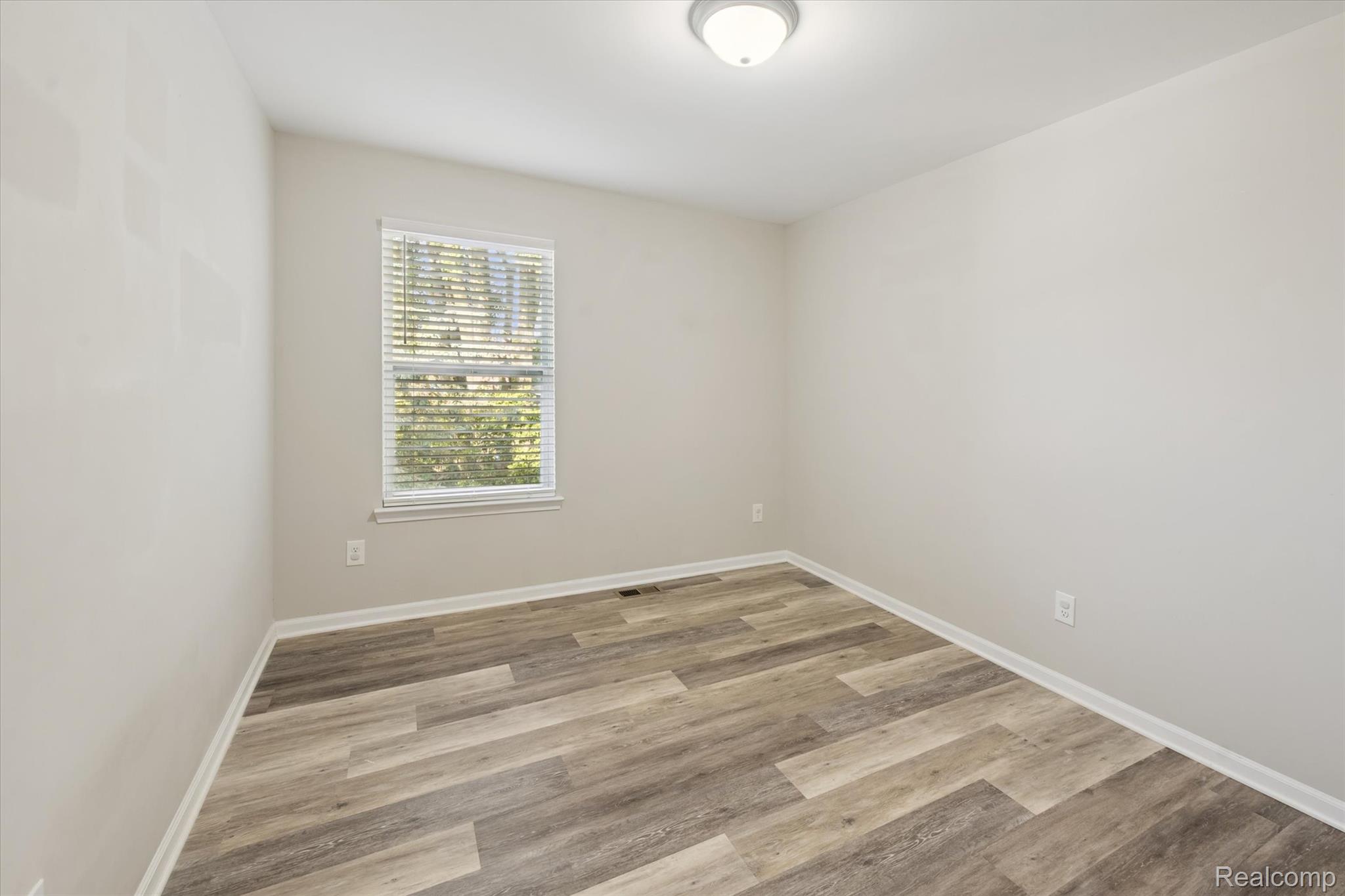 816 Nelson's Ridge Drive Howell, MI 48843 - Photo 15 of 36 Spacious bedroom with generous closet space and neutral décor.