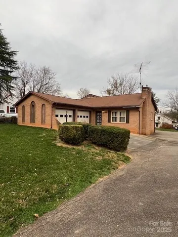 a front view of a house with a garden and yard