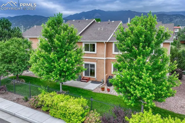 a aerial view of a house with a yard and potted plants
