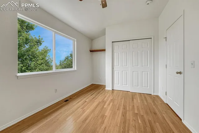 a view of a room with wooden floor and window