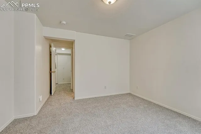 an empty room with closet and a bathroom