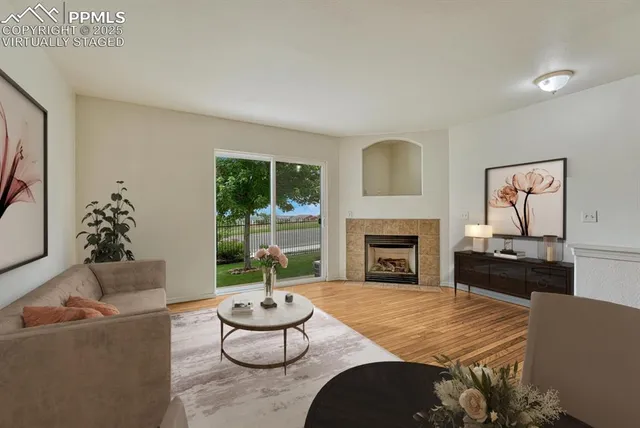 a living room with furniture and a fireplace