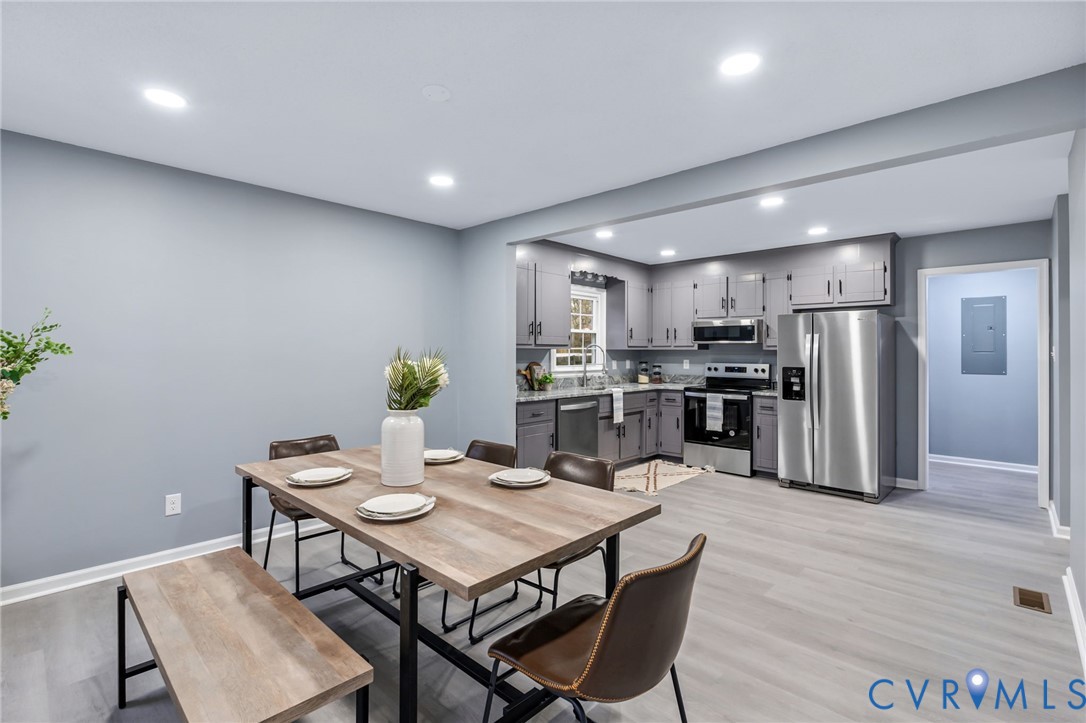17416 Chemin Road Petersburg, VA 23803 - Photo 13 of 29 a kitchen with a dining table cabinets appliances and wooden floor