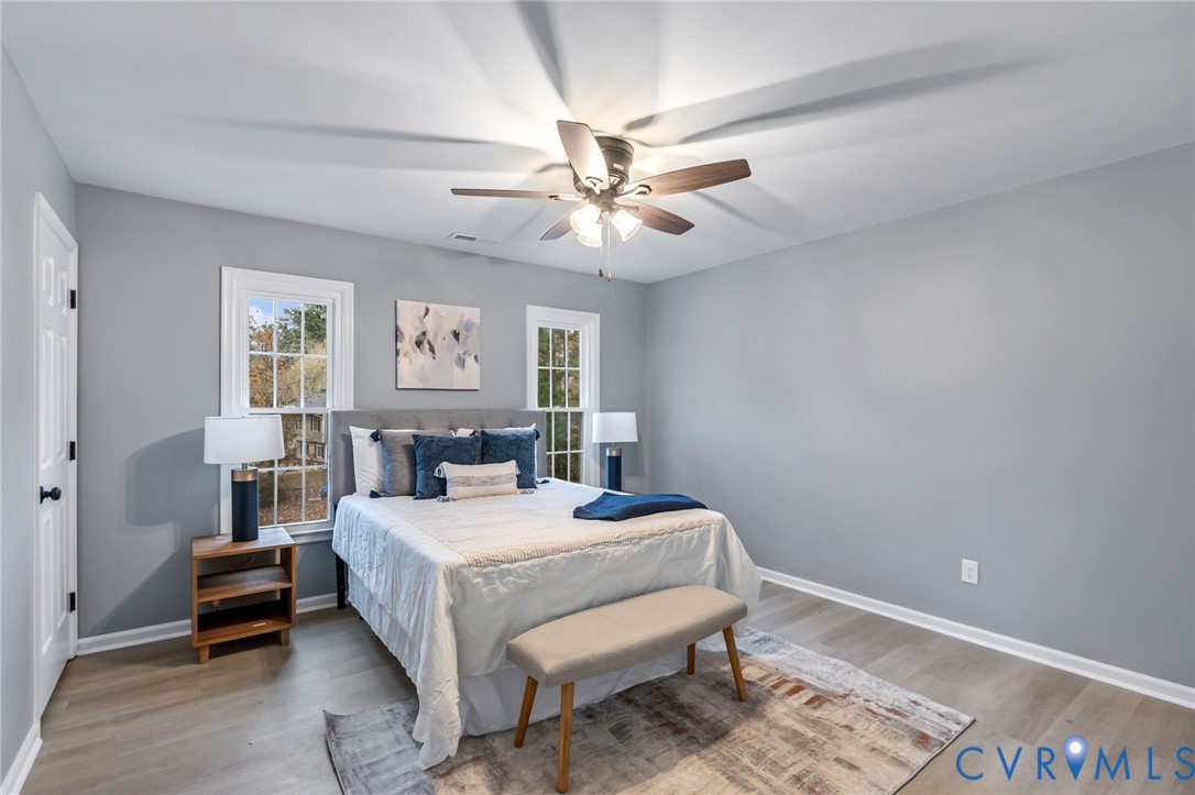 17416 Chemin Road Petersburg, VA 23803 - Photo 20 of 29 a bedroom with a bed and a chandelier