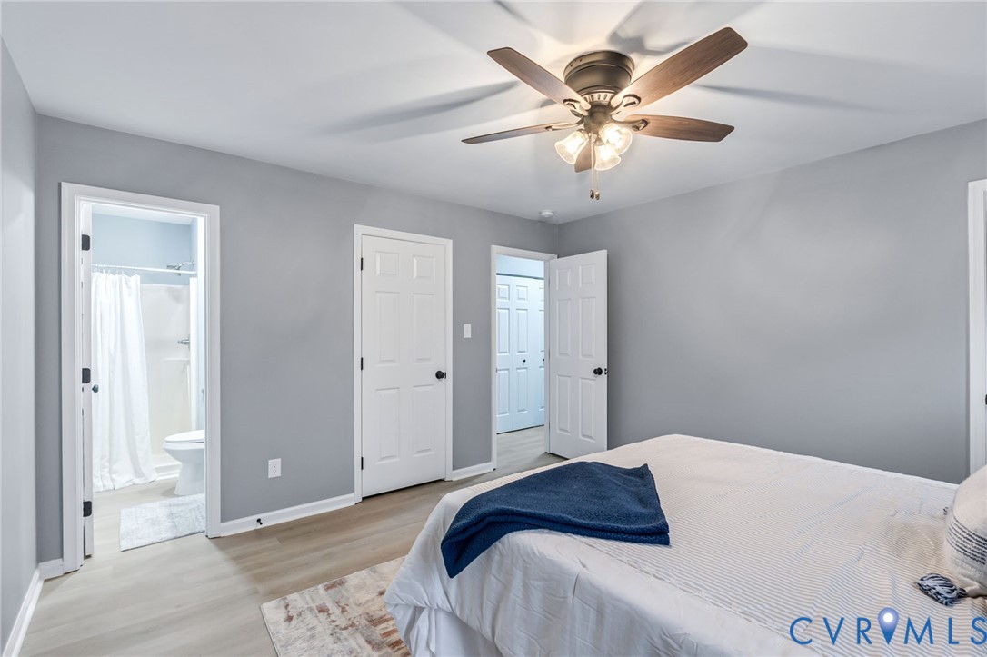 17416 Chemin Road Petersburg, VA 23803 - Photo 21 of 29 a bedroom with a large bed and a ceiling fan
