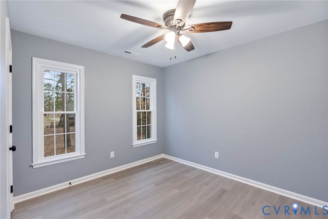 17416 Chemin Road Petersburg, VA 23803 - Photo 23 of 29 an empty room with windows and fan