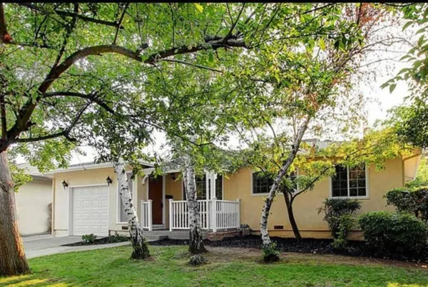 a view of house with backyard