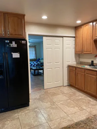 a view of kitchen with refrigerator cabinets and furniture