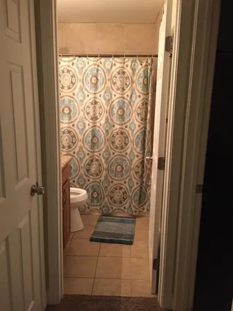 a view of bathroom with shower curtain