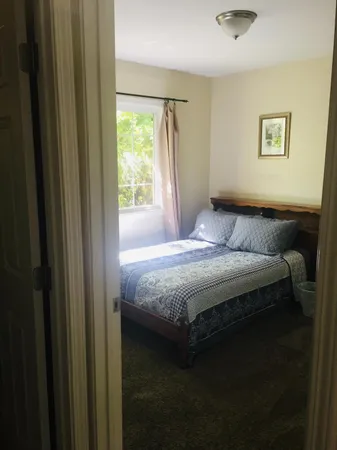 a bedroom with a bed and a window