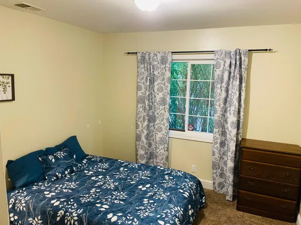 a bedroom with a bed and a window
