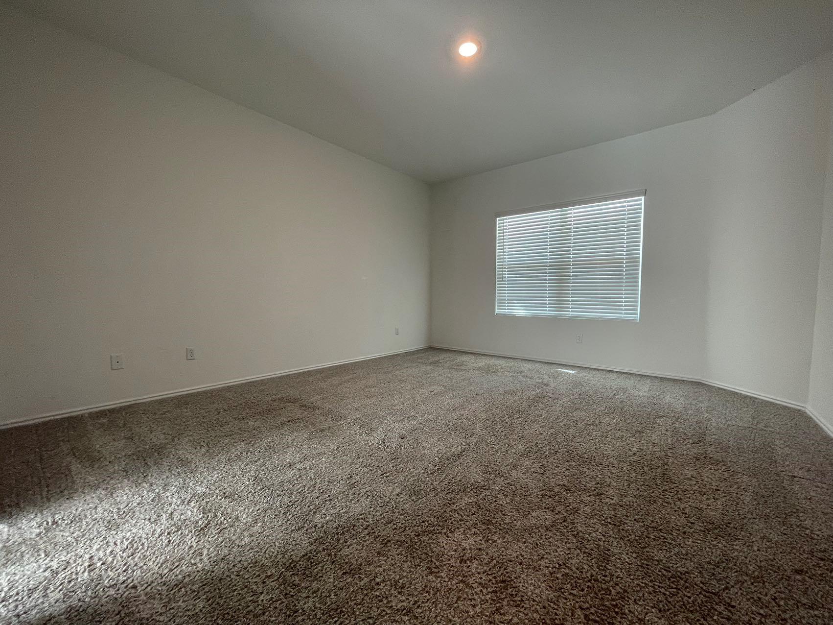 1625 Woolsey Way Leander, TX 78641 - Photo 11 of 17 Spacious room featuring neutral carpeting, light-colored walls, and a window with blinds providing natural light
