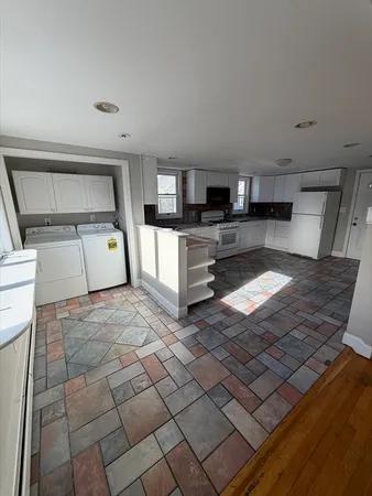 a kitchen with stainless steel appliances kitchen island granite countertop a sink and cabinets