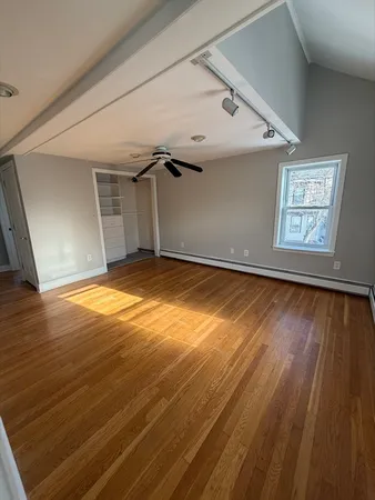 a view of an empty room and wooden floor