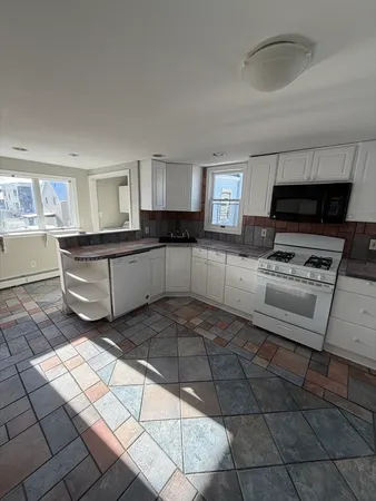 a kitchen with stainless steel appliances a stove a sink and a counter top space
