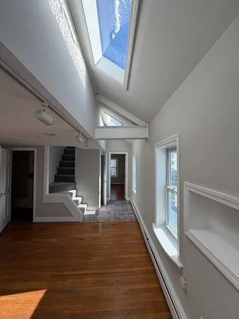 a view of a hallway view with wooden floor and staircase